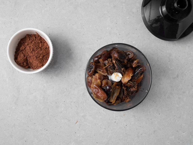 W pojemniku malaksera daktyle z tofu. Obok kakao w miseczce.