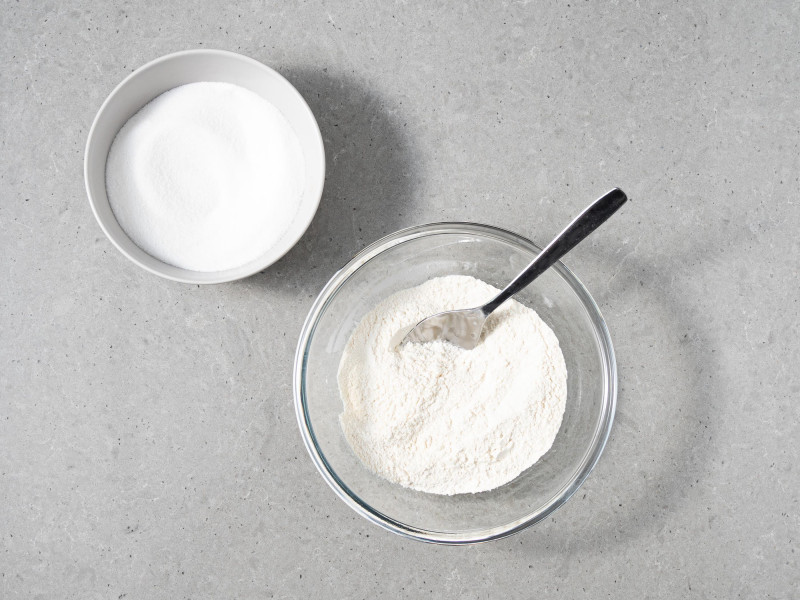 mąka pszenna i cukier w osobnych miseczkach