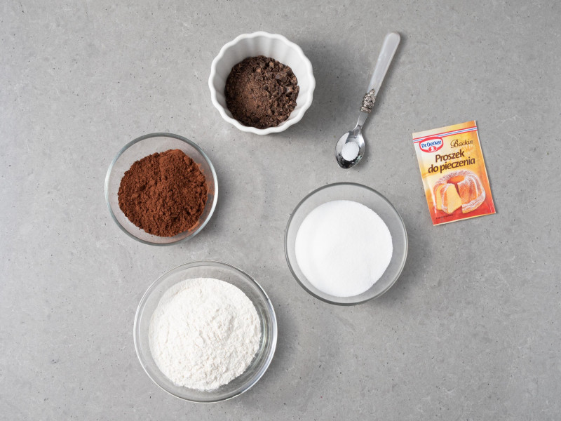 W miseczkach m膮ka pszenna, cukier, kakao, proszek do pieczenia, s贸l i czekolad臋.