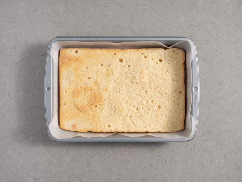 upieczony biszkopt waniliowy ze ściętym wierzchem w formie do pieczenia