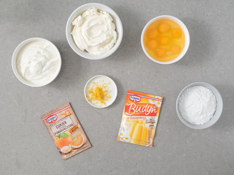 W miskach serek mascarpone, twaróg, jajka, cukier, cukier ze skórką pomarańczową, skórkę z cytryny i Budyń Dr. Oetkera.
