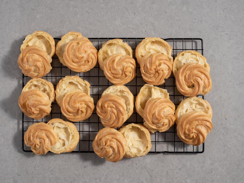 upieczone i przekrojone wpoprzek ptysie na kratce do studzenia