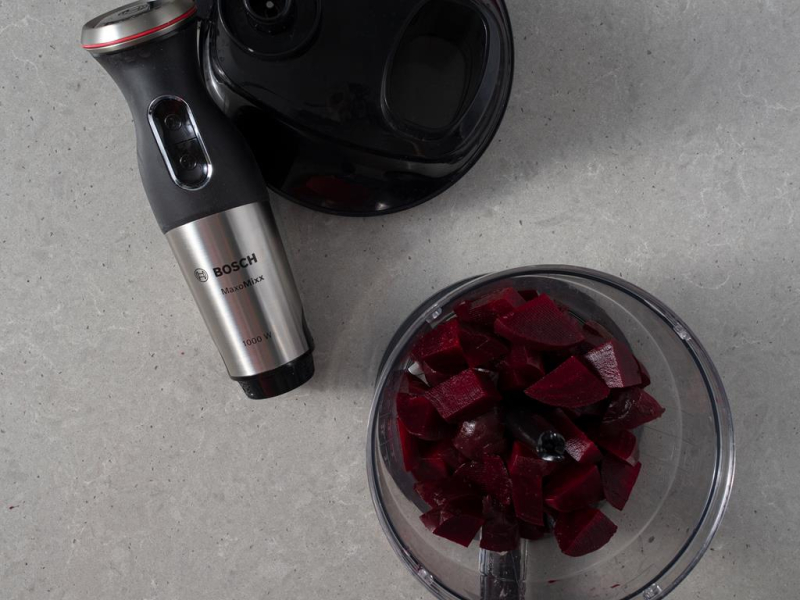 Blender ręczny firmy Bosch. Obok pokrojone buraki w malakserze.