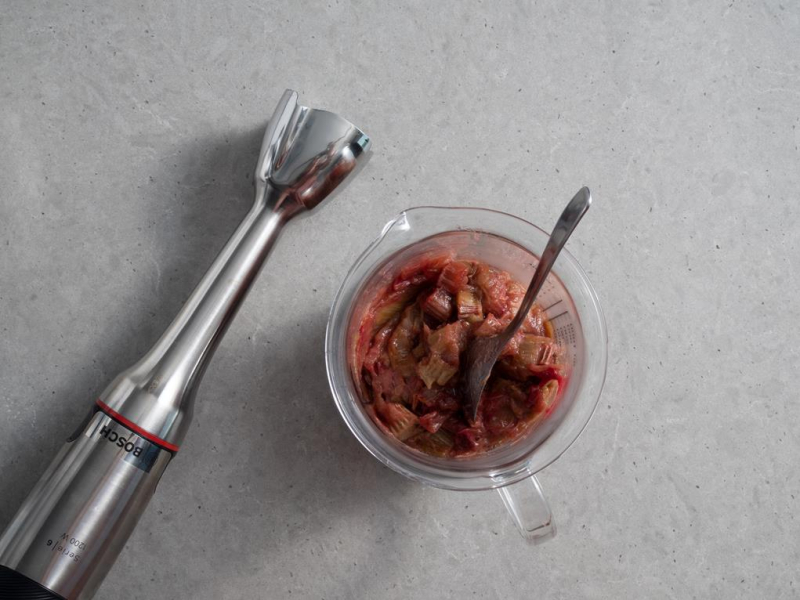 w wysokim naczyniu upieczony rabarbar obok ręczny blender bosch
