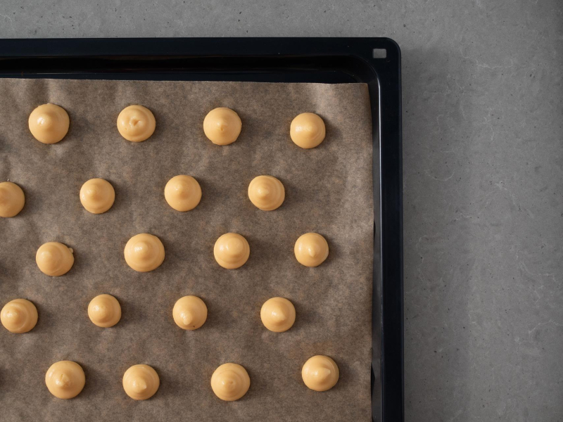 Przygotowane porcje ciasta na blasze.