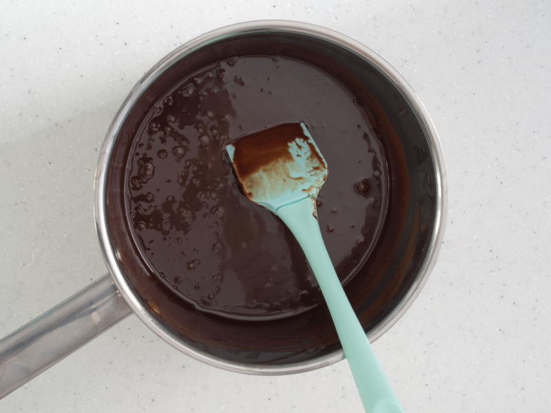 Roztopione cukierki truflowe ze śmietanką w garnku.