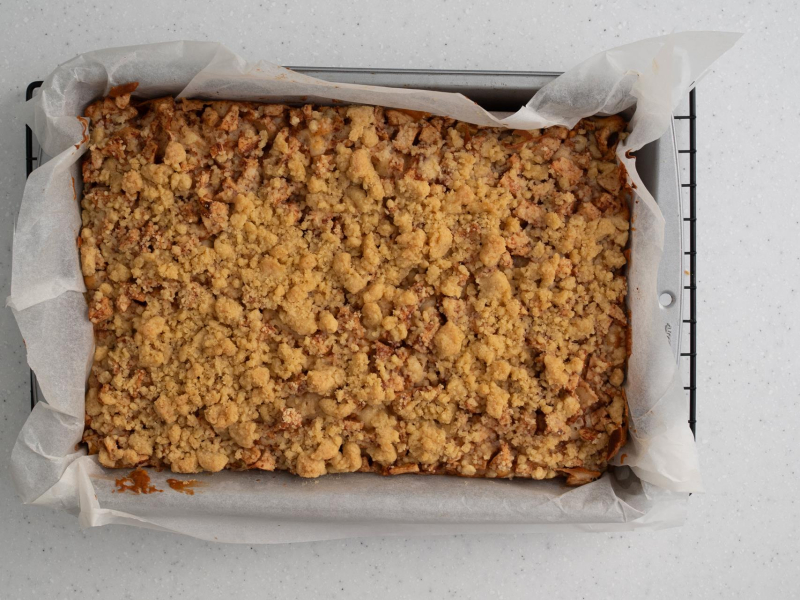 Upieczone ciasto jogurtowe z jabłkami i cynamonem i kruszonką.