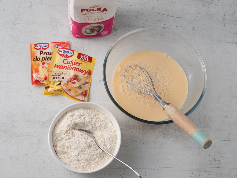 na blacie proszek do pieczenia i cukier wanilinowy, mąka polka i miska ze składnikami na gofry