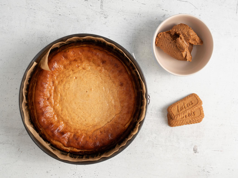 Upieczony skyrnik lotus. A obok ciasteczka lotus i masa ciasteczkowa w miseczce.