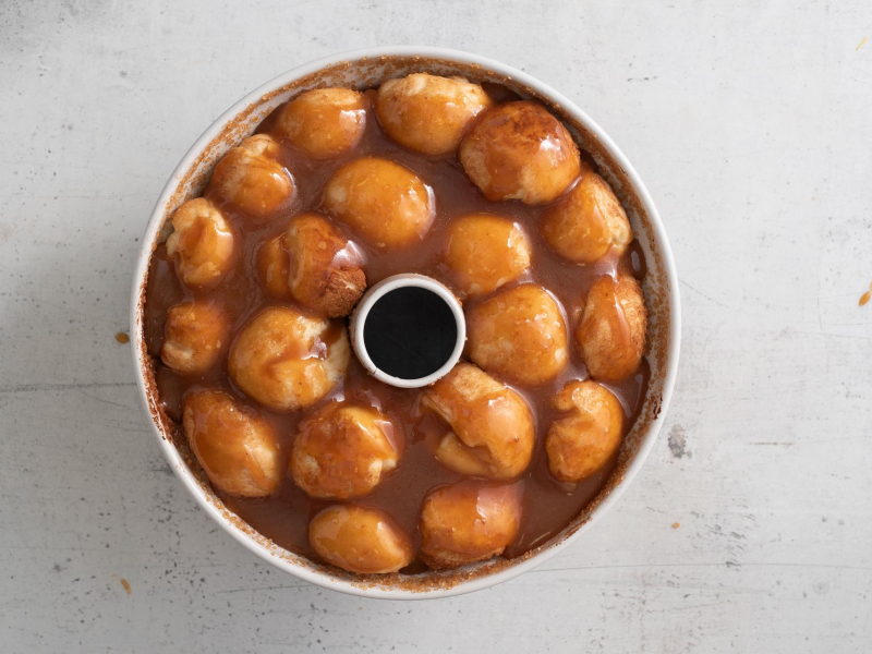 Ciasto małpi chlebek przed pieczeniem, zalane sosem karmelowym.