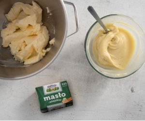 Kostka masła i utarte masło. Obok masa z białej czekolady.